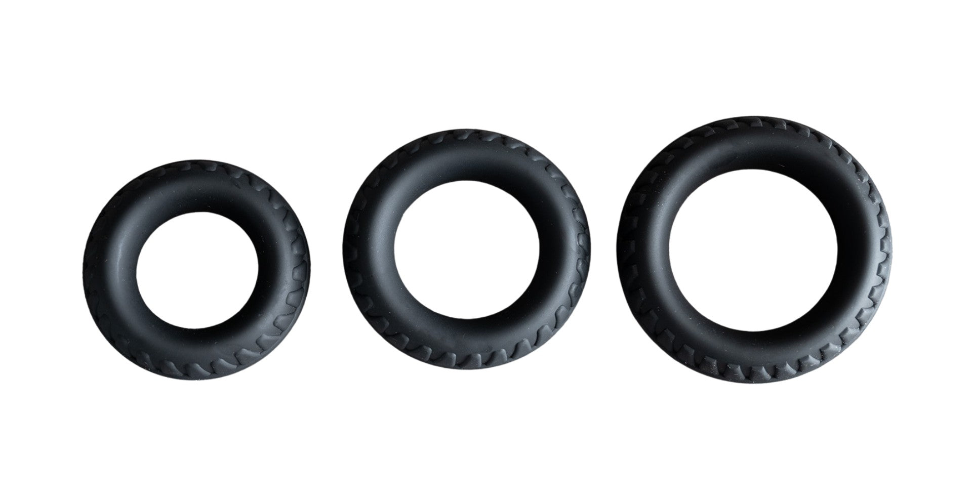 three body-safe silicone cock rings lined up on white background