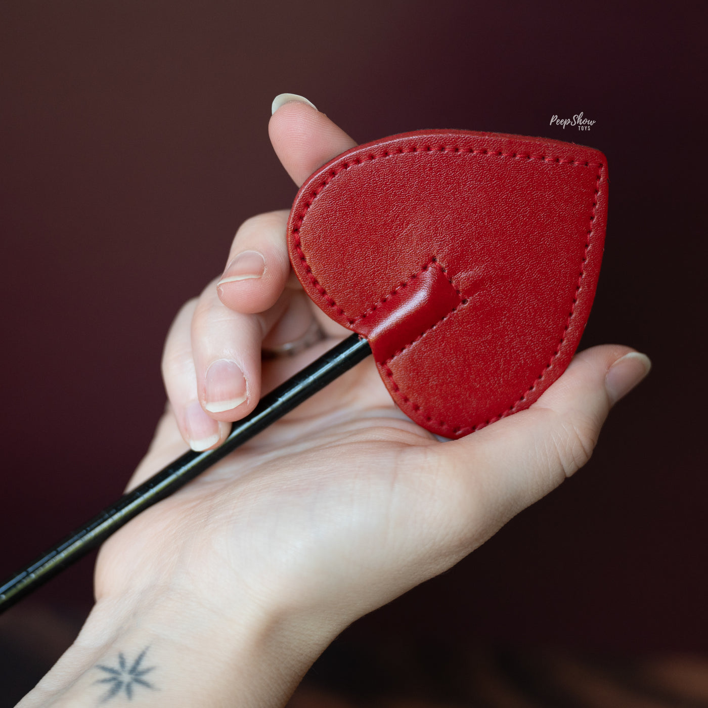 Red Leather Mini Spade Paddle in hand